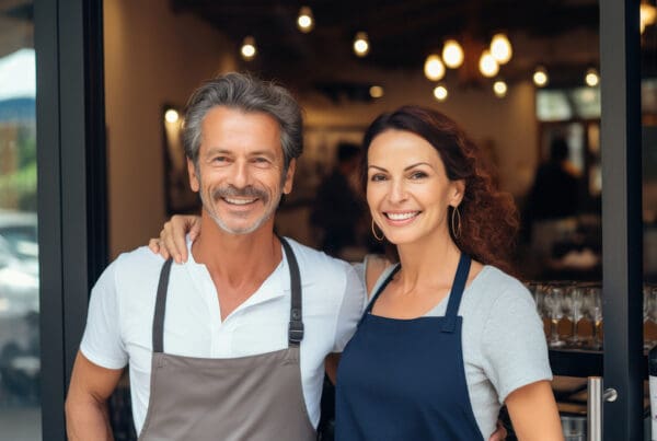 Insurance by Industry - Cheerful Small Business Owners Standing at a Restaurant Entrance
